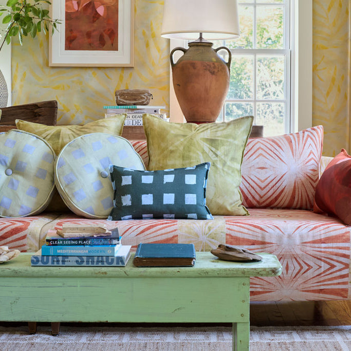 Modernity (Preppy) lumbar, Modernity (Sachet) round and Palmetto pillows on a sofa in a Palm wallpaper living room