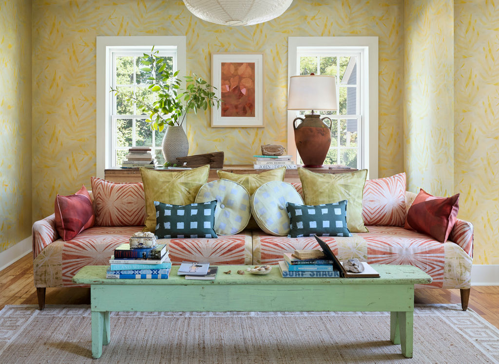 SeaSong Collection: Palm wallpaper with Palmetto, Marsh Ember and Portico pillows on a sofa