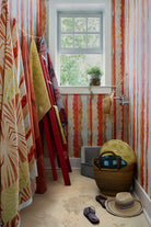 Modernity (Rubber Duck) and Modernity (Preppy) round pillows in a basket beside Cassis wallpaper